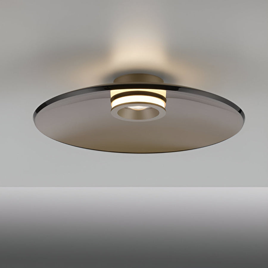 Modern wall light fixture with a glass shade on a gray background