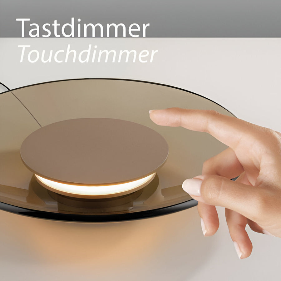 Hand touching a touchdimmer switch on a light fixture with 'Tastdimmer Touchdimmer' text.