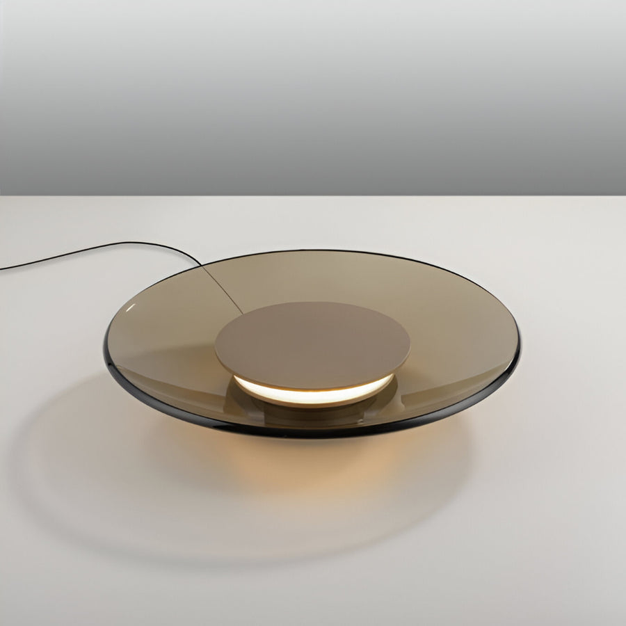 Glass plate with a metallic base on a white surface