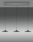 Three pendant kinetic lights hanging from a ceiling fixture against a gray background