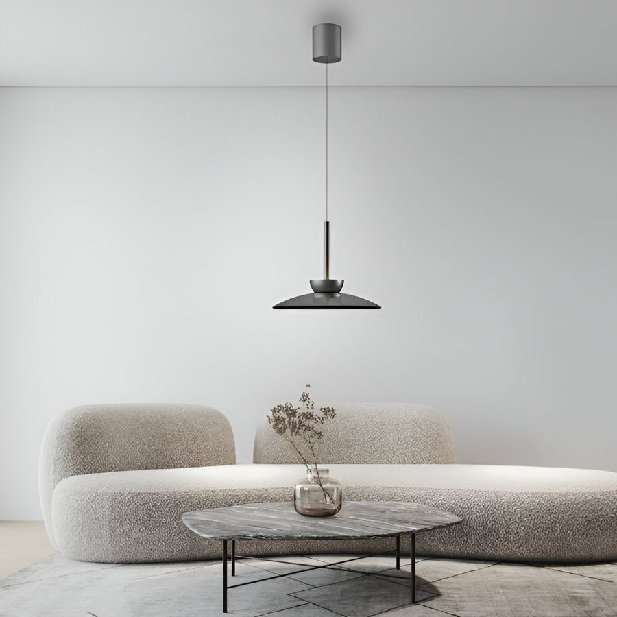 Modern living room with a beige sofa, small table, and a manual lift pendant light.