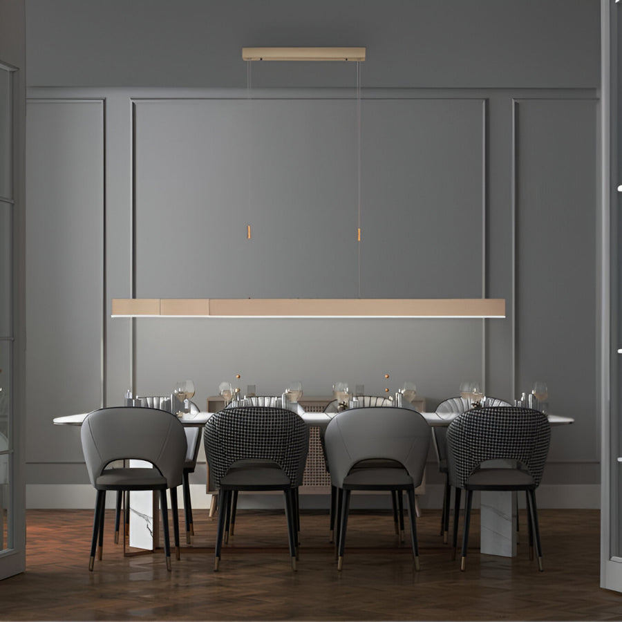 Modern dining room with a long table and chairs under kinetic pendant lights.