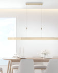 Modern dining room with a long rectangular pendant kinetic light fixture.