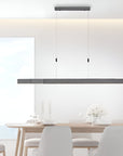 Modern dining room with a long linear pendant kinetic light fixture.