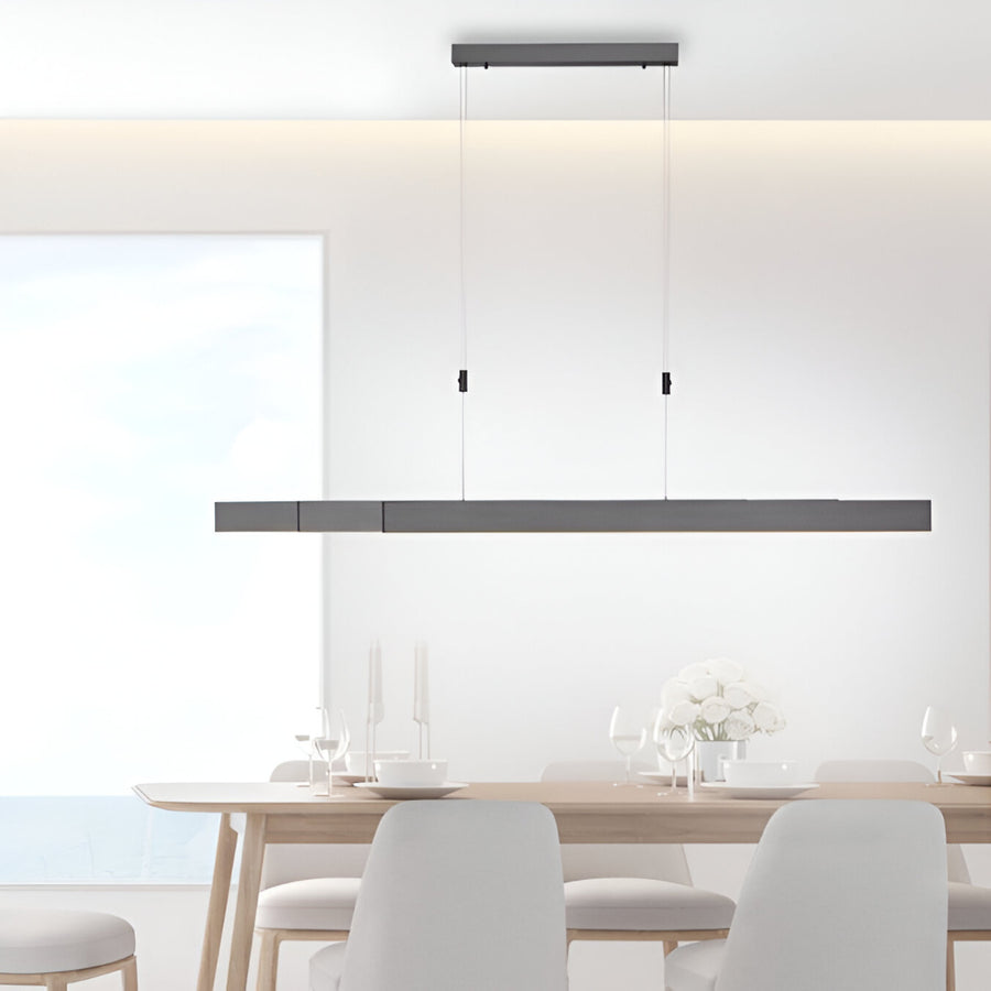 Modern dining room with a long linear pendant kinetic light fixture.