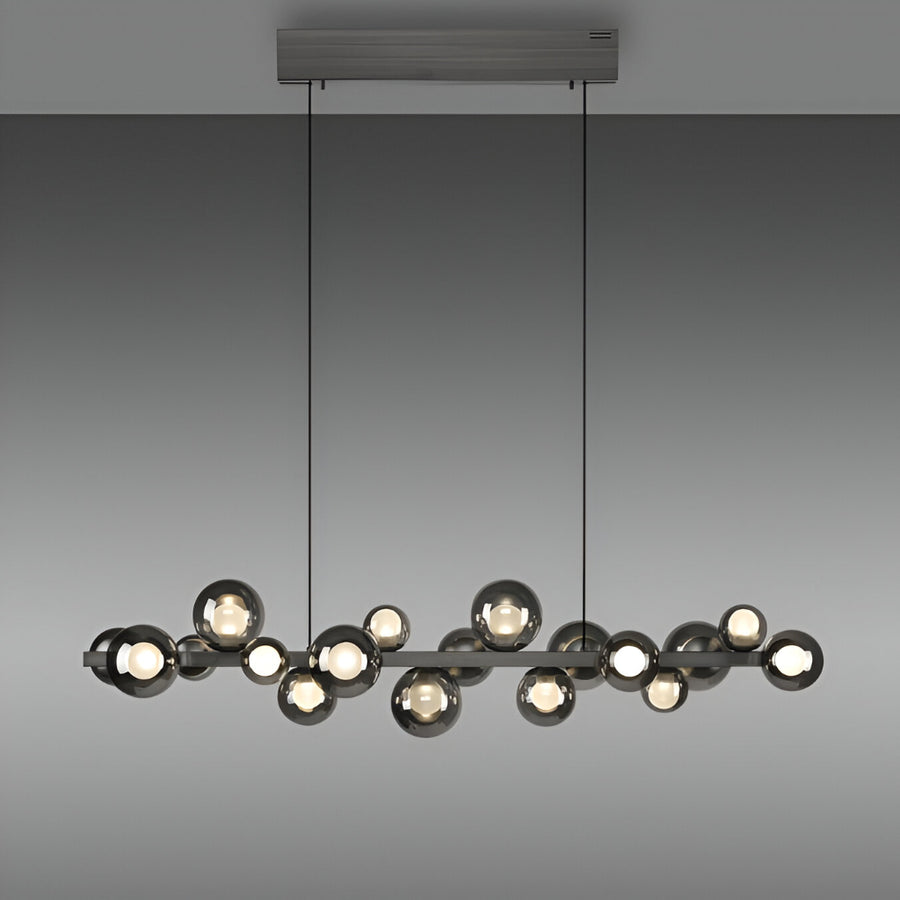 Modern kinetic pendant light fixture with multiple bulbs on a gray background