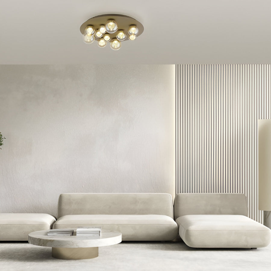 Modern living room with a beige sofa, coffee table, and ceiling light fixture.