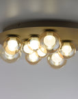 Ceiling light fixture with multiple bulbs on a plain background