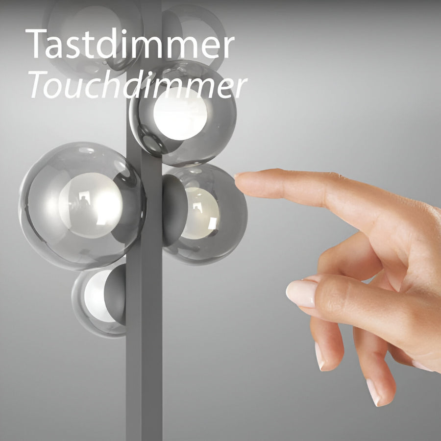 Hand touching a touchdimmer switch on a light fixture with 'Tastdimmer Touchdimmer' text.