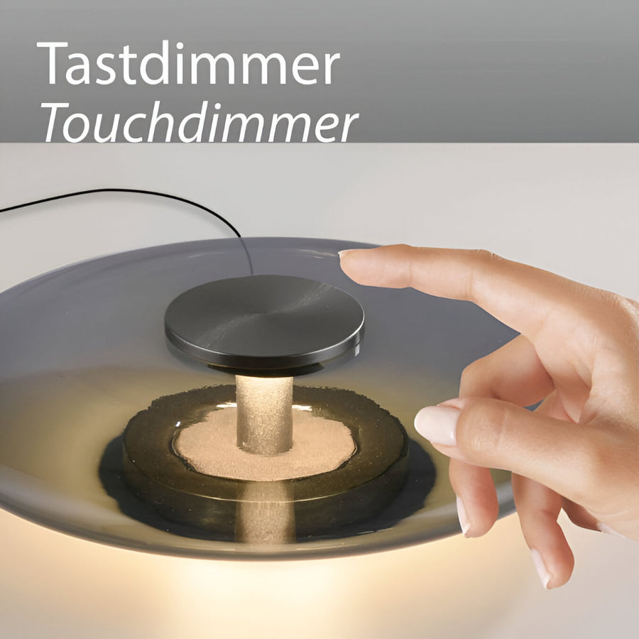Hand interacting with a touchdimmer switch on a light fixture, with text 'Tastdimmer Touchdimmer' above.