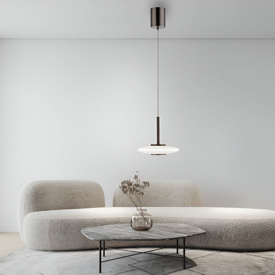 Modern living room with a gray sofa, small table, and pendant light.