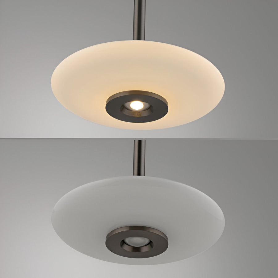 Modern pendant light with a white glass shade on a gray background