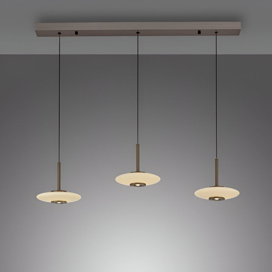 Modern pendant light fixture with three hanging lights on a gray background