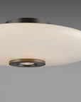 Ceiling light fixture with white glass shade and bronze metal accents on a gray background
