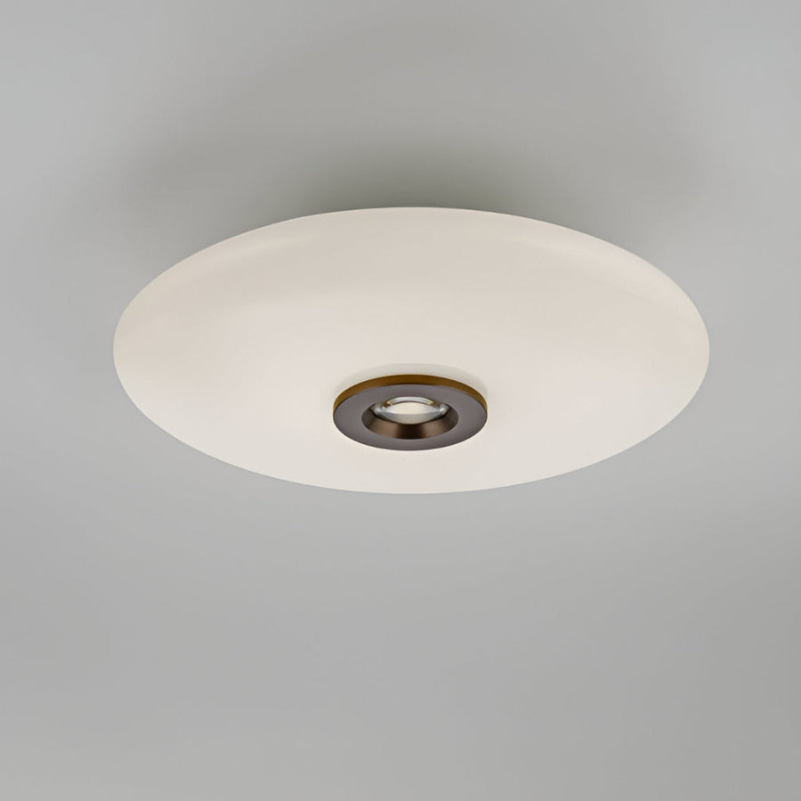 Ceiling light fixture with white shade and bronze fixture on a gray background