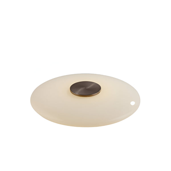 Round table lamp with a beige glass shade and bronze metal fixture on a white background