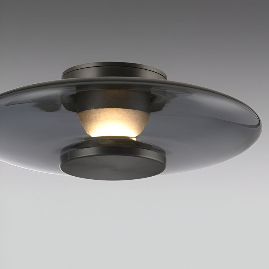 Ceiling light fixture with glass shade on a gray background