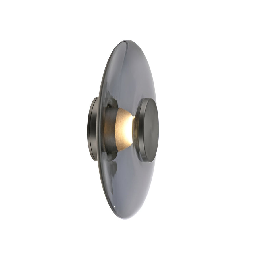 Decorative wall light fixture with a metallic finish on a white background