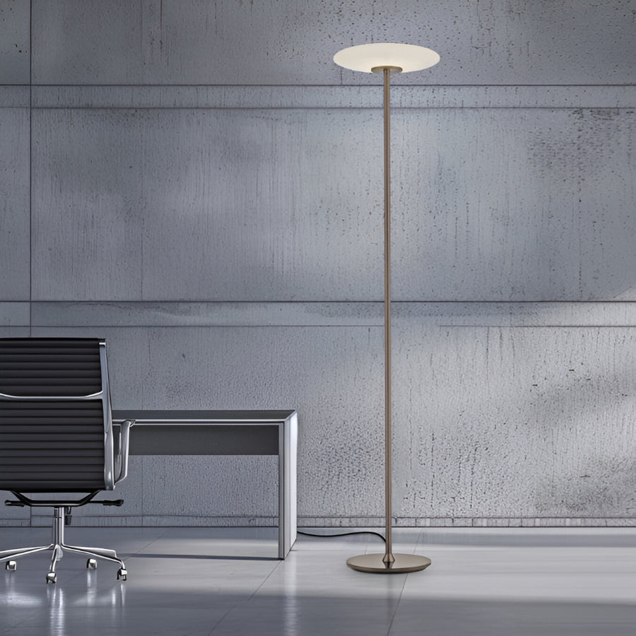 Modern floor lamp in a minimalistic office setting with a chair and desk.