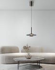 Modern living room with a gray sofa, small table, and manual lift pendant light.