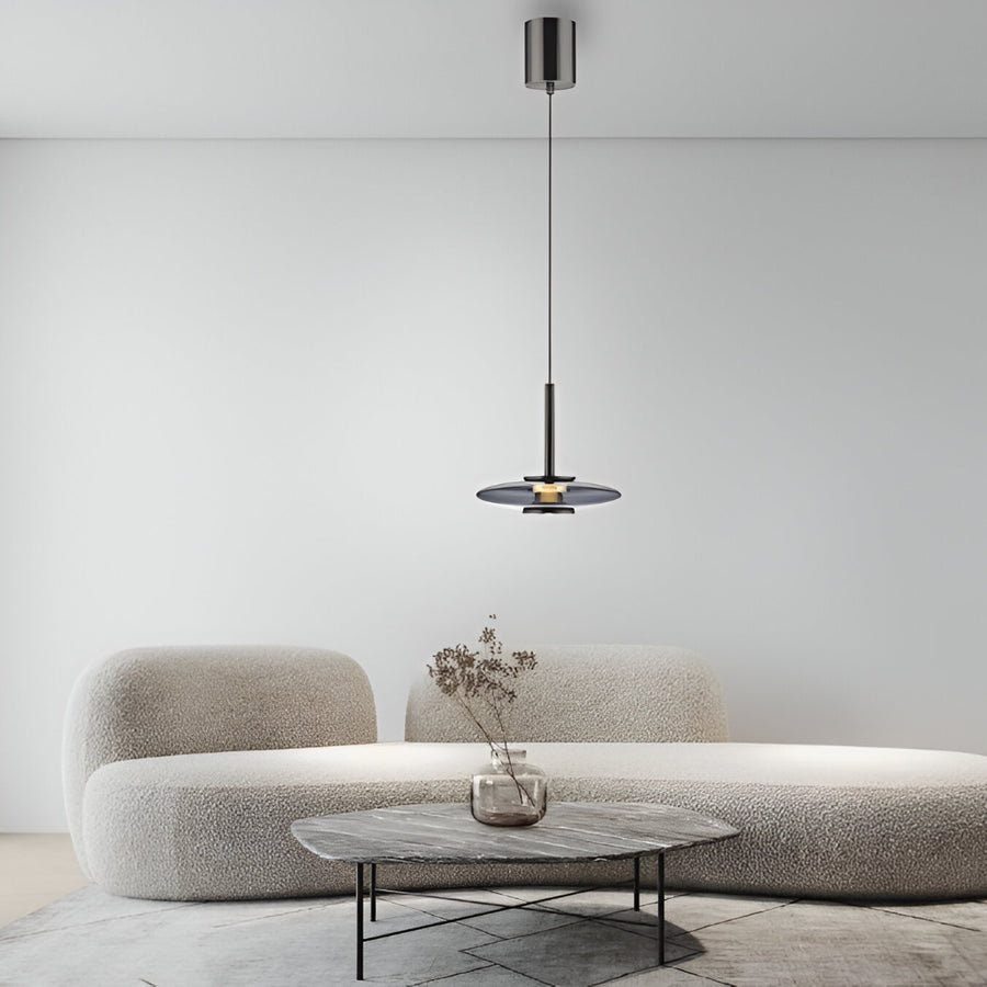 Modern living room with a gray sofa, small table, and manual lift pendant light.