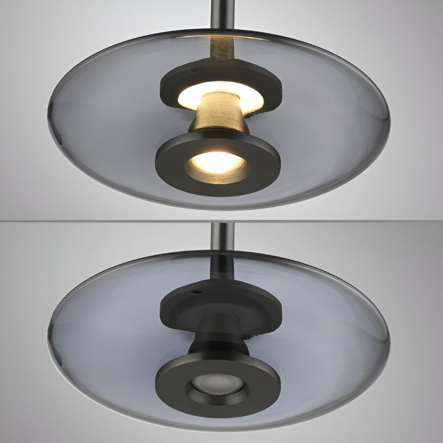 Modern pendant light with glass shades on a neutral background