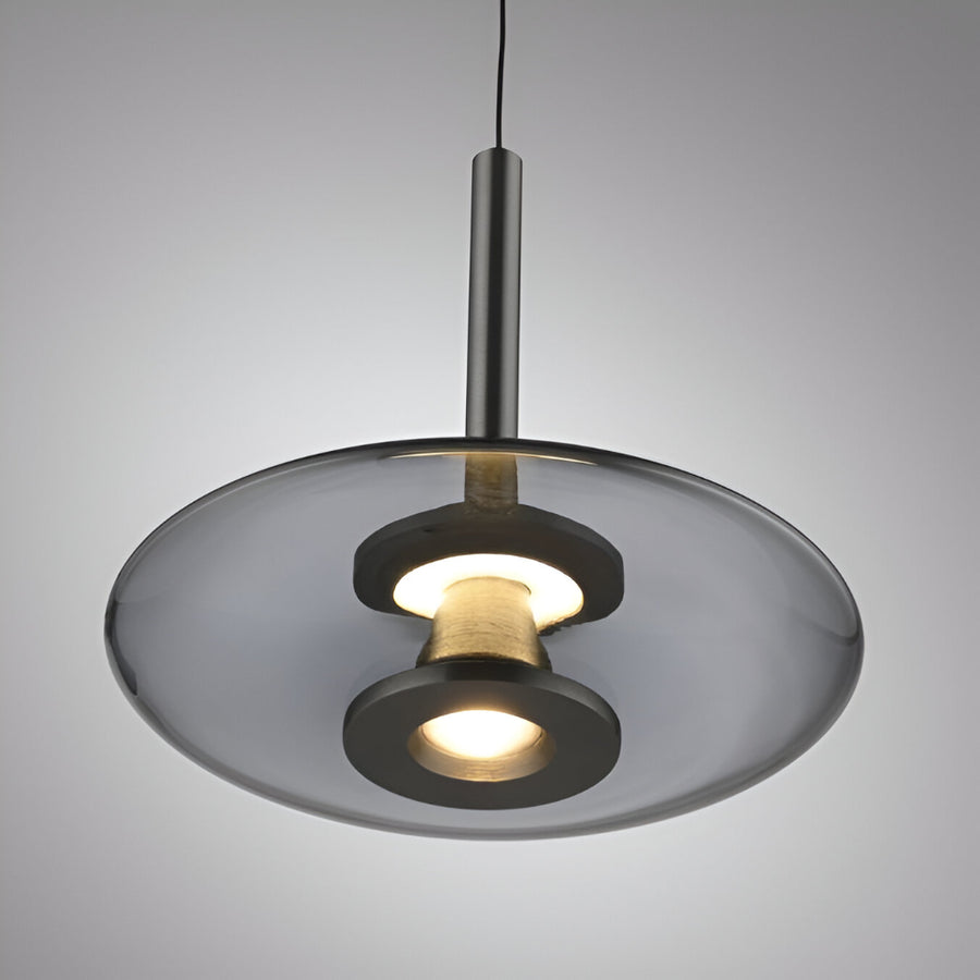 Modern pendant light with a gray glass shade on a gray background