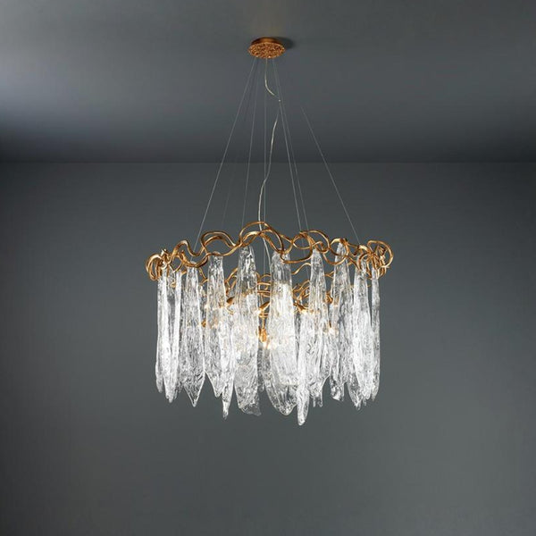 Chandelier with gold frame and clear glass elements on a dark gray background
