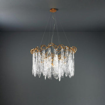 Chandelier with gold frame and clear glass elements on a dark gray background
