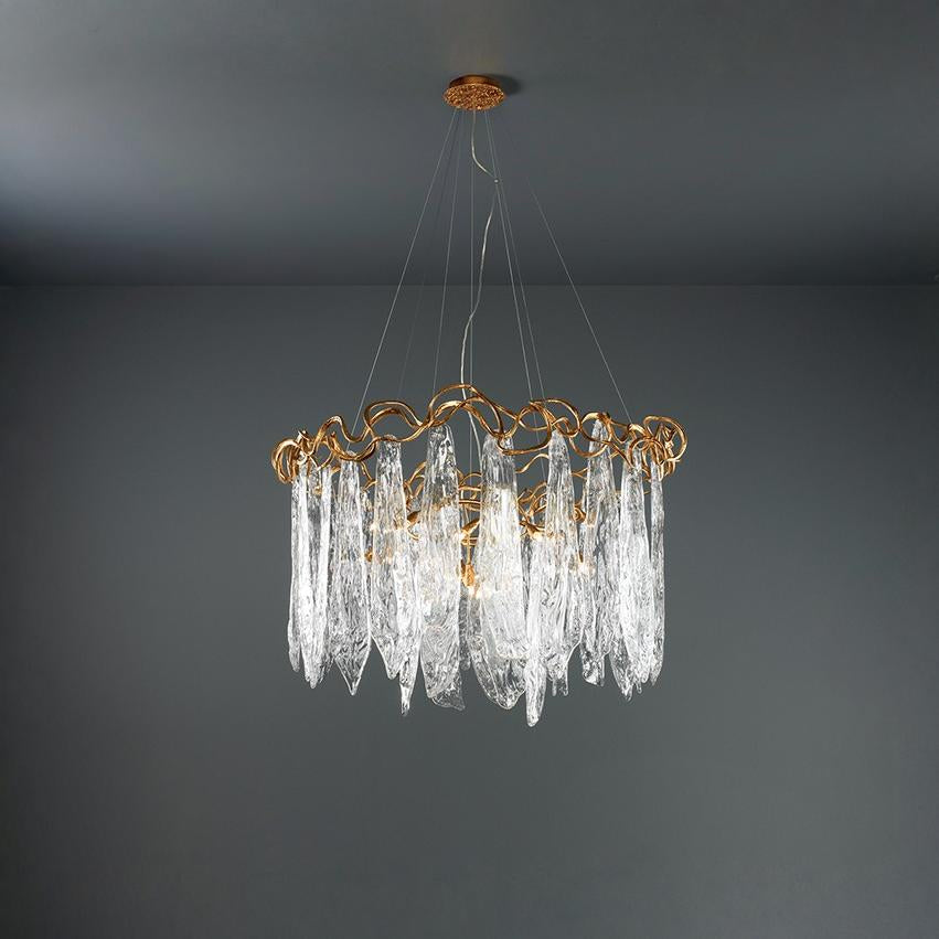 Chandelier with gold frame and clear glass elements on a dark gray background