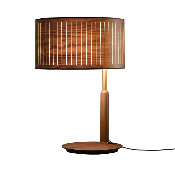 Wooden table lamp with a wooden brown shade and brass detailing on a white background from Nomon available at Spacio retail stores in Mumbai & Kolkata. 