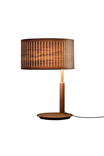 Wooden table lamp with a wooden brown shade and brass detailing on a white background from Nomon available at Spacio retail stores in Mumbai & Kolkata. 