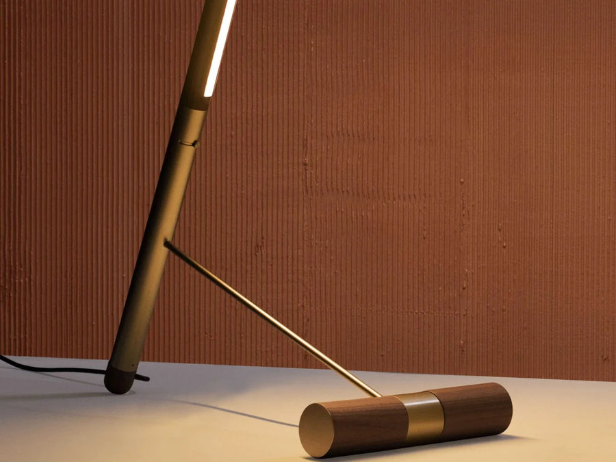 Wooden floor lamp in walnut wood and brass from Nomon available at Spacio retail stores in Mumbai & Kolkata. 
