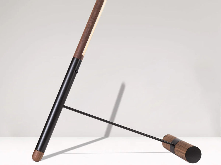 Modern floor lamp with wooden accents on a white background