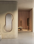 Modern bedroom with a unique floor mirror and minimal decor.