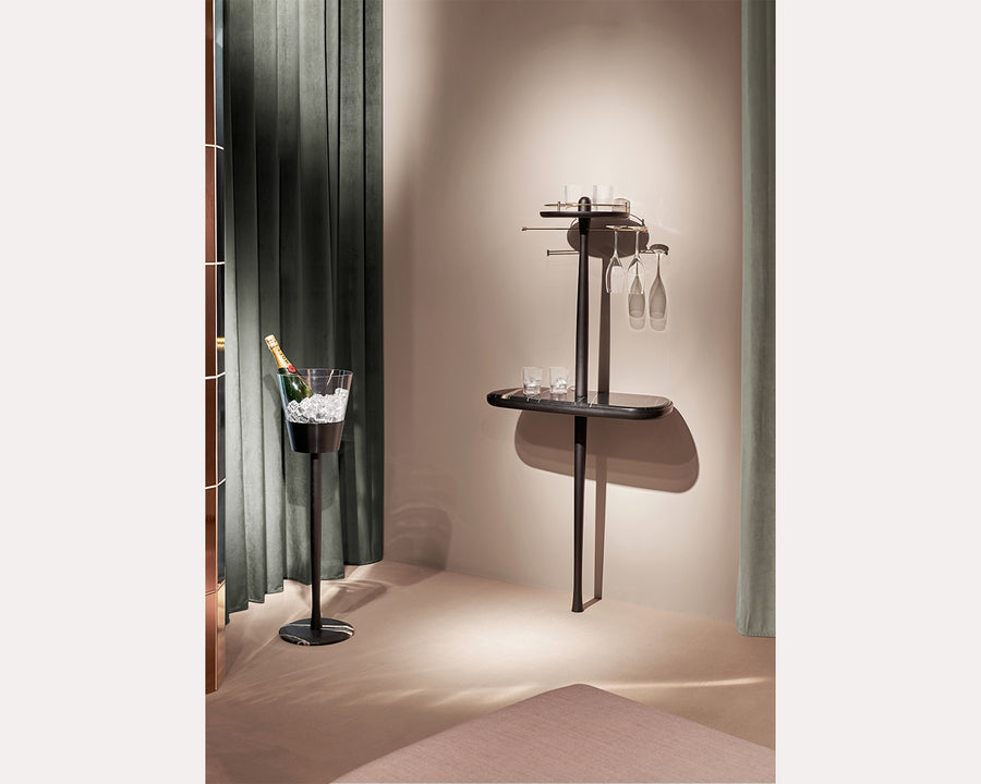 Modern wall-mounted wine rack with glasses in a stylish interior setting.