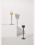 Two wine chillers on a white surface with a light gray background