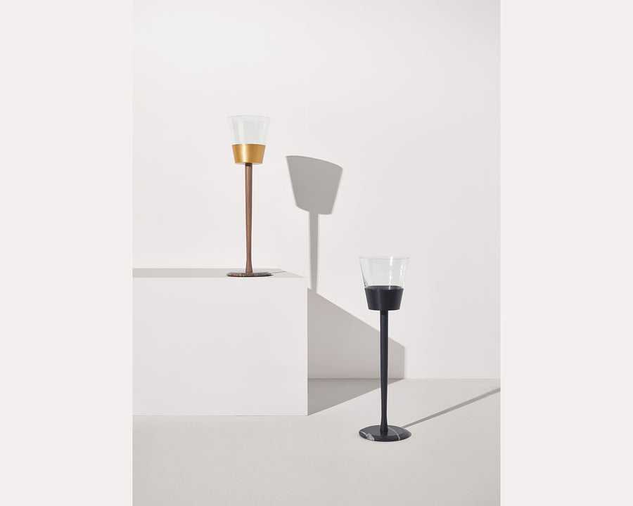 Two wine chillers on a white surface with a light gray background
