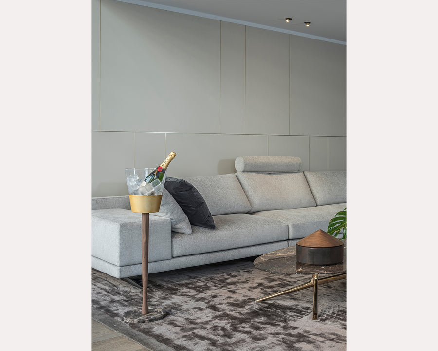 Gray sectional sofa in a modern living room with a champagne chiller stand