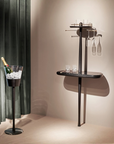 Modern wall-mounted wine rack with glasses in a stylish interior setting.