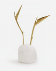 Small white quartz sculpture with gold bird of paradise flower on a white background
