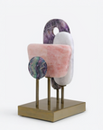 Decorative sculpture with multicolored circular quartz elements on a white background