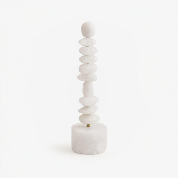 Stack of white quartz totem sculpture on a white background