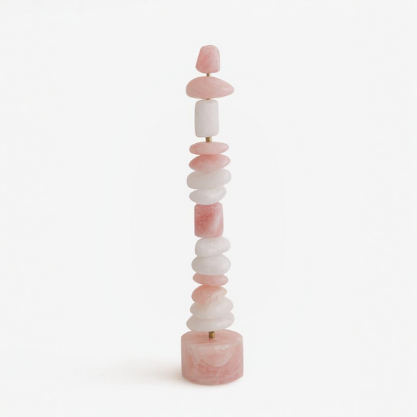 Stacked pink and white quartz table top totem sculpture on a white background