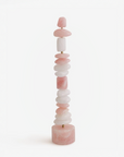 Stacked pink and white quartz table top totem sculpture on a white background
