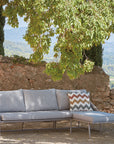 A Sifas Basket Sofa Collection, placed in front of a stone wall, from the Sifas brand.