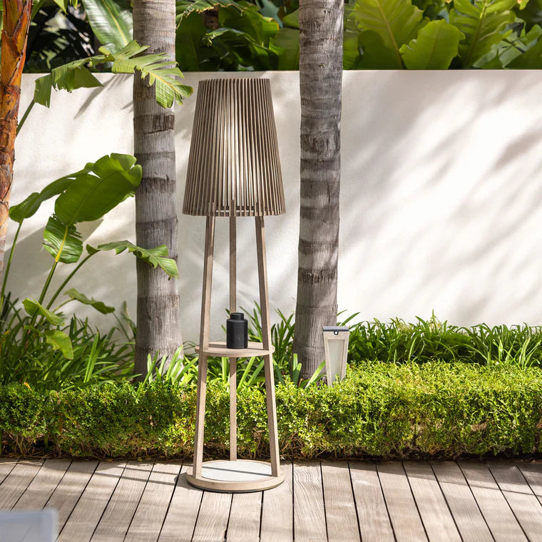 Tall outdoor floor lamp and side table with pleated design in a garden setting  by Les Jardins available at Spacio retail stores in Mumbai & Kolkata. 
