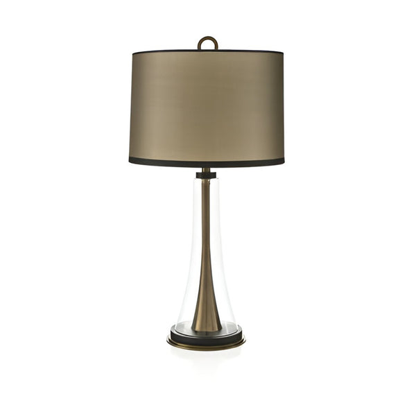 Table lamp with a bronze shade and clear base on a white background from Pieter Adam available at Spacio in India. 