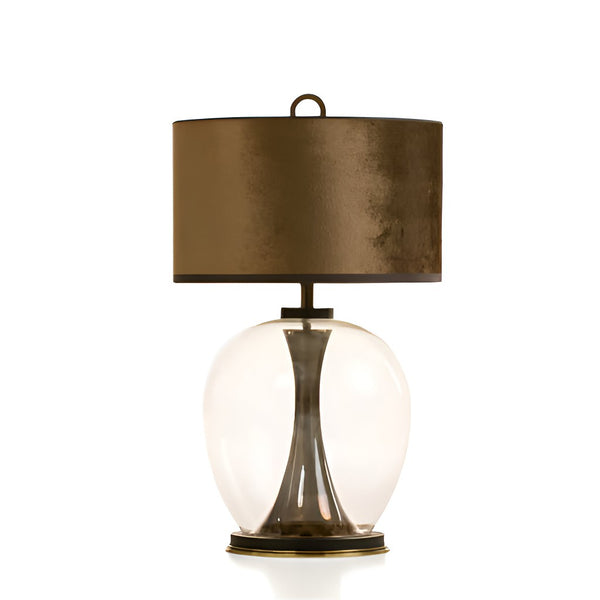 Table lamp with bronze shade and glass base on a white background from Pieter Adam available at Spacio in India. 