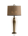 Table lamp with a brown shade and brass base on a white background